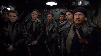 Movie still from “U-571” (2000), directed by Jonathan Mostow – A group of men standing next to each other in a room; Medium shot, High angle