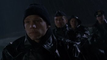 Movie still from “U-571” (2000), directed by Jonathan Mostow – A group of men standing next to each other in the rain; Close Up shot, Low angle
