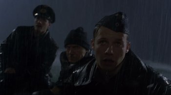Movie still from “U-571” (2000), directed by Jonathan Mostow – A group of men standing next to each other in the rain; Close Up shot, Low angle