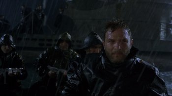 Movie still from “U-571” (2000), directed by Jonathan Mostow – A group of men in rain gear with guns in hand; Close Up shot, Low angle
