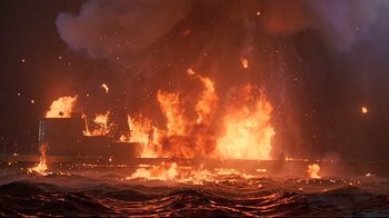 Movie still from “U-571” (2000), directed by Jonathan Mostow – A fire is burning in the middle of the night; Extreme Wide shot, High angle