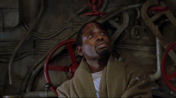 Movie still from “U-571” (2000), directed by Jonathan Mostow – A man in a robe looking up into the sky; Close Up shot, Low angle