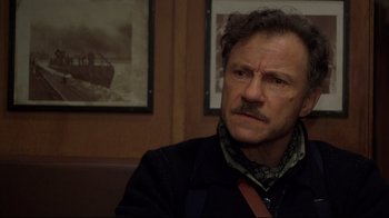 Movie still from “U-571” (2000), directed by Jonathan Mostow – A person sitting in a room; Close Up shot, Over the shoulder angle