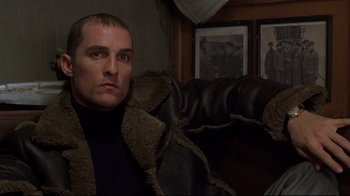 Movie still from “U-571” (2000), directed by Jonathan Mostow – A person sitting on a couch; Close Up shot, Over the shoulder angle