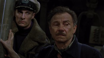 Movie still from “U-571” (2000), directed by Jonathan Mostow – A man in a military uniform and a man in a military uniform; Close Up shot, Over the shoulder angle