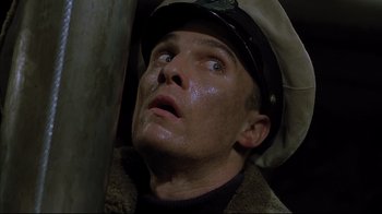 Movie still from “U-571” (2000), directed by Jonathan Mostow – A person wearing a hat; Close Up shot, Low angle