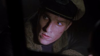 Movie still from “U-571” (2000), directed by Jonathan Mostow – A person wearing a hat and jacket; Close Up shot, Low angle