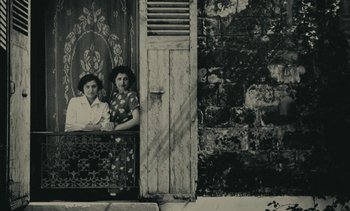 Movie still from “Ulysse” (1983), directed by Agnès Varda – A couple of women sitting next to each other on a bench; Wide shot, Overhead angle