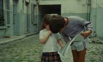 Movie still from “Ulysse” (1983), directed by Agnès Varda – A girl and a boy looking at each other on the street; Medium shot, High angle