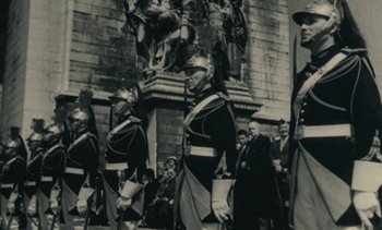 Movie still from “Ulysse” (1983), directed by Agnès Varda – A black and white photo of a group of men in uniform; Wide shot, Low angle