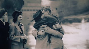 Movie still from “Unbroken: Path to Redemption” (2018), directed by Harold Cronk – A couple of people that are hugging each other; Wide shot, High angle