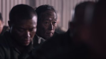 Movie still from “Unbroken: Path to Redemption” (2018), directed by Harold Cronk – An older man is looking into the distance; Close Up shot, Over the shoulder angle