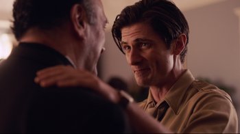 Movie still from “Unbroken: Path to Redemption” (2018), directed by Harold Cronk – A man is adjusting a tie of another man; Close Up shot, Over the shoulder angle