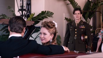 Movie still from “Unbroken: Path to Redemption” (2018), directed by Harold Cronk – A man and a woman dressed up in military uniforms; Medium shot, Over the shoulder angle