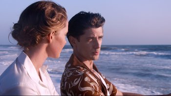 Movie still from “Unbroken: Path to Redemption” (2018), directed by Harold Cronk – A man and a woman standing next to each other on the beach; Medium shot, Over the shoulder angle