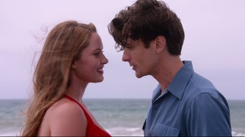 Movie still from “Unbroken: Path to Redemption” (2018), directed by Harold Cronk – A man and a woman standing next to each other on the beach; Close Up shot, Over the shoulder angle