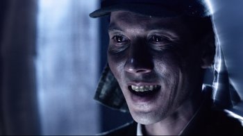 Movie still from “Unbroken: Path to Redemption” (2018), directed by Harold Cronk – A person wearing a hat; Close Up shot, Low angle