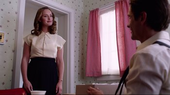 Movie still from “Unbroken: Path to Redemption” (2018), directed by Harold Cronk – A woman standing in front of a man in front of a window; Medium shot, Over the shoulder angle