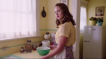 Movie still from “Unbroken: Path to Redemption” (2018), directed by Harold Cronk – A woman standing in front of a bowl in a kitchen; Medium shot, Low angle