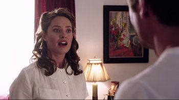 Movie still from “Unbroken: Path to Redemption” (2018), directed by Harold Cronk – A woman in a white shirt talking to a man in a white shirt; Medium shot, Over the shoulder angle