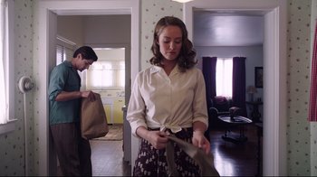 Movie still from “Unbroken: Path to Redemption” (2018), directed by Harold Cronk – A woman holding a knife in her hands; Medium shot, Low angle