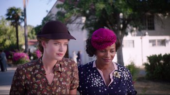 Movie still from “Unbroken: Path to Redemption” (2018), directed by Harold Cronk – Two women wearing hats are standing next to each other; Close Up shot, Over the shoulder angle