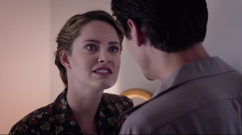 Movie still from “Unbroken: Path to Redemption” (2018), directed by Harold Cronk – A woman looking at a young man in front of a mirror; Close Up shot, Over the shoulder angle