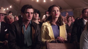 Movie still from “Unbroken: Path to Redemption” (2018), directed by Harold Cronk – A man and a woman standing next to each other; Medium shot, Over the shoulder angle