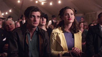 Movie still from “Unbroken: Path to Redemption” (2018), directed by Harold Cronk – A man and a woman sitting next to each other; Close Up shot, Over the shoulder angle