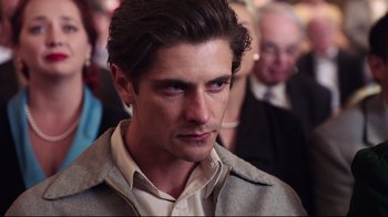 Movie still from “Unbroken: Path to Redemption” (2018), directed by Harold Cronk – A person wearing a jacket; Close Up shot, Over the shoulder angle