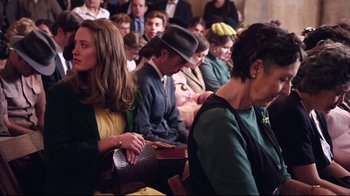 Movie still from “Unbroken: Path to Redemption” (2018), directed by Harold Cronk – A group of people sitting in a room; Medium shot, Over the shoulder angle