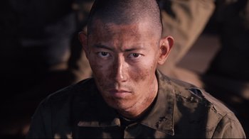 Movie still from “Unbroken: Path to Redemption” (2018), directed by Harold Cronk – A person wearing a uniform; Close Up shot, Low angle