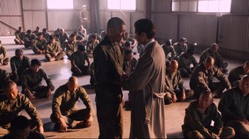 Movie still from “Unbroken: Path to Redemption” (2018), directed by Harold Cronk – A group of men sitting in a room; Wide shot, High angle