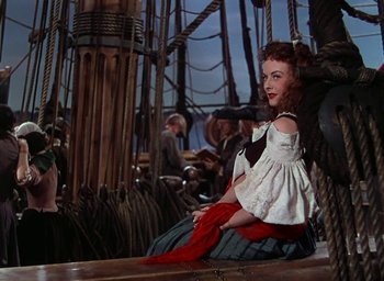Movie still from “Unconquered” (1947), directed by Cecil B. DeMille – A woman sitting on the deck of a ship; Medium shot, High angle