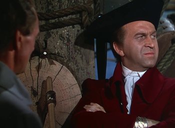 Movie still from “Unconquered” (1947), directed by Cecil B. DeMille – A man wearing a red jacket and a black hat; Medium shot, Over the shoulder angle