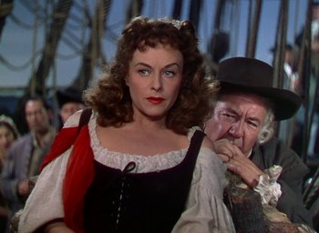 Movie still from “Unconquered” (1947), directed by Cecil B. DeMille – A woman wearing a red and white dress and a man wearing a black hat; Close Up shot, Over the shoulder angle