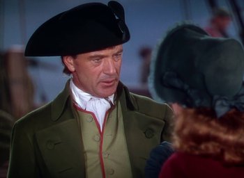 Movie still from “Unconquered” (1947), directed by Cecil B. DeMille – A man wearing a hat and a green jacket; Medium shot, Over the shoulder angle