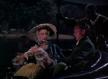 Movie still from “Unconquered” (1947), directed by Cecil B. DeMille – A man and a woman sitting in a carriage; Medium shot, High angle