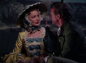 Movie still from “Unconquered” (1947), directed by Cecil B. DeMille – A man and a woman dressed in period clothing; Medium shot, Over the shoulder angle