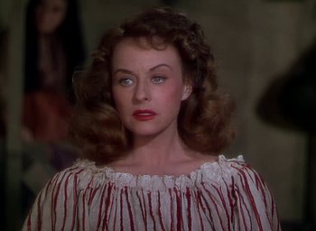 Movie still from “Unconquered” (1947), directed by Cecil B. DeMille – A person wearing a dress; Close Up shot, Over the shoulder angle