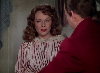 Movie still from “Unconquered” (1947), directed by Cecil B. DeMille – A woman in a red and white striped dress looking at a man in a red and white striped shirt; Close Up shot, Over the shoulder angle