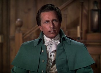 Movie still from “Unconquered” (1947), directed by Cecil B. DeMille – A person wearing a suit and tie; Close Up shot, Low angle