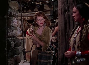 Movie still from “Unconquered” (1947), directed by Cecil B. DeMille – A woman holding a wooden stick in front of another woman; Medium shot, Over the shoulder angle