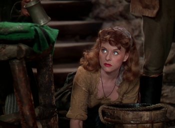 Movie still from “Unconquered” (1947), directed by Cecil B. DeMille – A woman with a red hair and a brown shirt is looking up; Medium shot, High angle