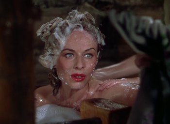 Movie still from “Unconquered” (1947), directed by Cecil B. DeMille – A woman in a tub with her hair in the shower; Close Up shot, High angle