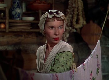 Movie still from “Unconquered” (1947), directed by Cecil B. DeMille – A woman in a green and white dress with a hat on; Close Up shot, Low angle