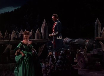 Movie still from “Unconquered” (1947), directed by Cecil B. DeMille – A man and a woman dressed in period clothing; Wide shot, High angle
