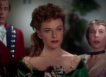 Movie still from “Unconquered” (1947), directed by Cecil B. DeMille – A person wearing a dress; Close Up shot, Over the shoulder angle
