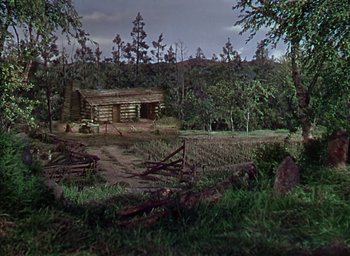Movie still from “Unconquered” (1947), directed by Cecil B. DeMille – An old log cabin in the middle of the woods; Extreme Wide shot, High angle