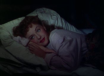 Movie still from “Unconquered” (1947), directed by Cecil B. DeMille – A woman laying in a bed under a blanket; Close Up shot, Overhead angle